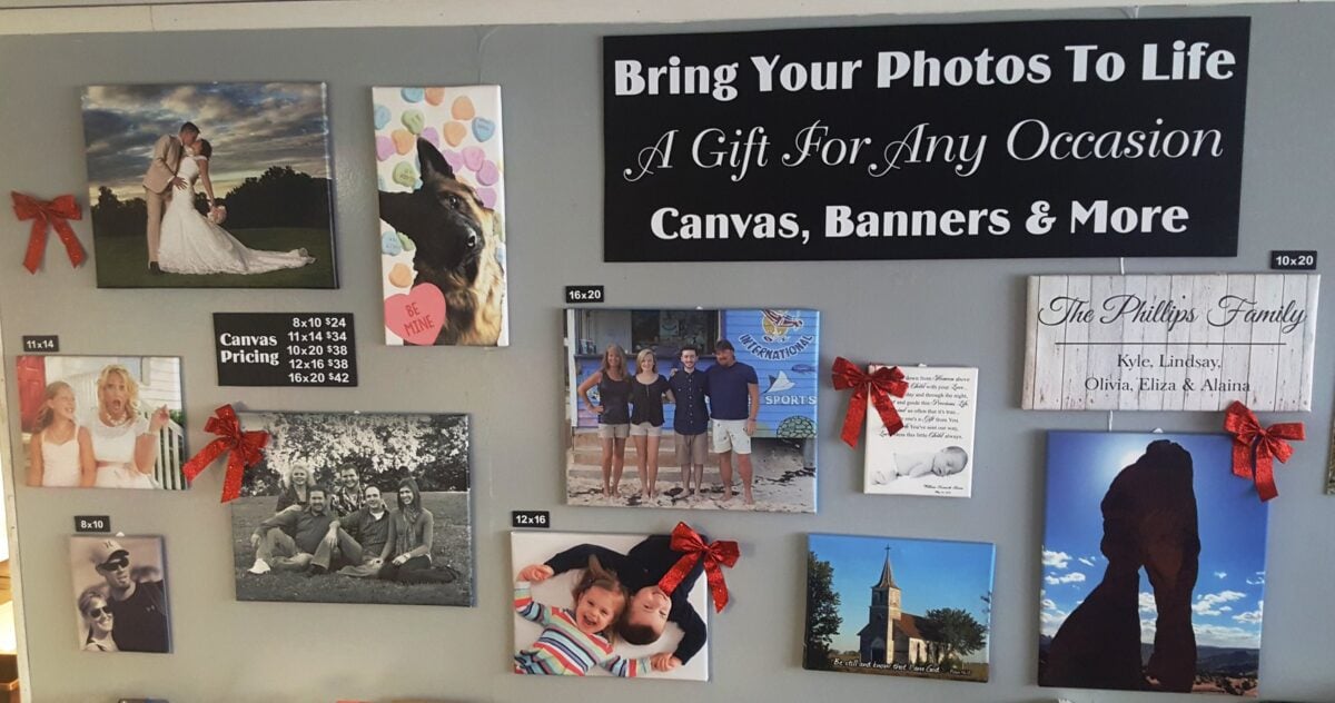 A wall featuring different canvas print photos.